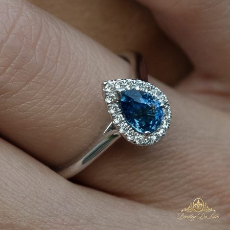 Blue-pear-sapphire-halo-ring-bentley-de-lisle-hand-paddington